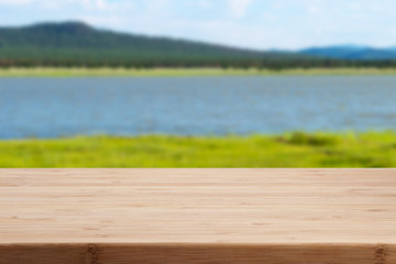Wooden empty table with green background