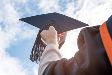 Graduates of the University,Of graduates holding hats handed to