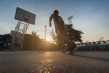 Fototapeta premium Basketball players playing basketball outdoor.
