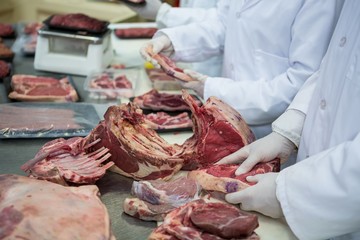Butcher cleaning meat