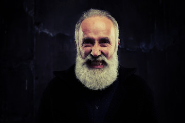 Bearded man grimacing, having wrinkles on his face