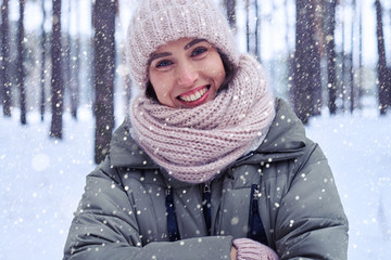 Fototapeta na wymiar Close-up of toothy smiling model in the winter forest