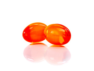 Red supplement capsules isolated on white background