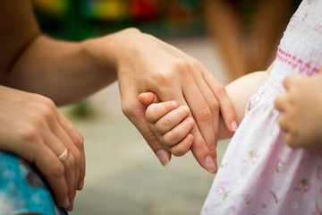 Hands of small baby and nice mom