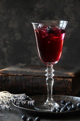 Close up of galss of red wine with berries