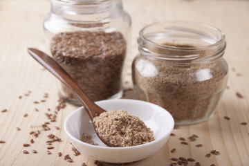 Flax flour in a wooden spoon