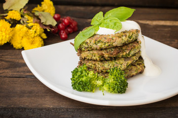 Broccoli and spinach pancakes with yogurt dressing  fresh herbs.