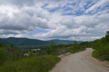The road down to the village and the mountain range in the dista