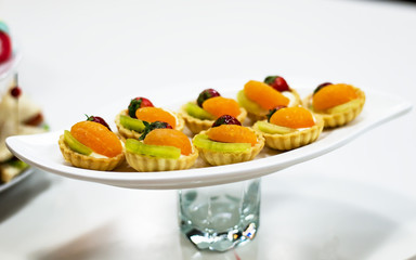 Snack breaks.Fresh baked glazed donut on sale under glass case.Close up,focus on donuts.Tasty sweet dessert for coffee break.Buy and eat delicious bakery product