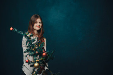woman, tree with toys, holiday