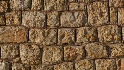 Texture of the old yellow stone wall outside