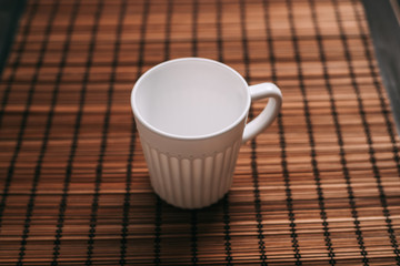 light mug on a wooden napkin
