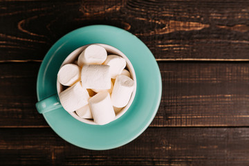 Fototapeta na wymiar Cup of marshmallow on the dark background