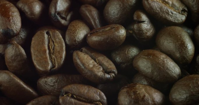 Macro shot of a roasted coffee bean. close up of high-quality arabic coffee with, produced in Brazil, Colombia and Venezuela.   