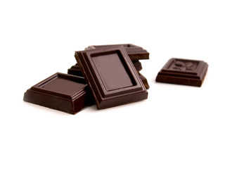 broken bar of dark chocolate on isolated white background