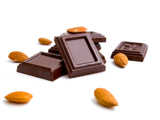 broken bar of dark chocolate on isolated white background