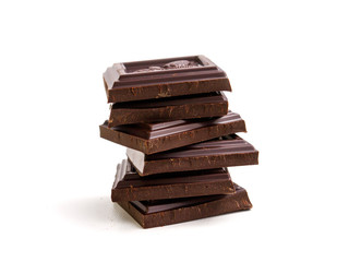 broken bar of dark chocolate on isolated white background