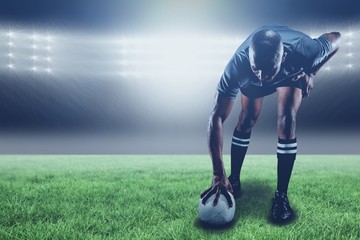 Composite image of rugby player taking position and 3d 