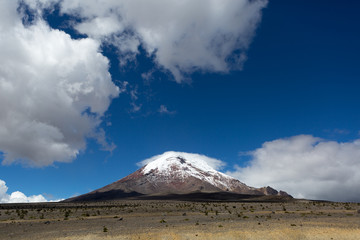 Fototapeta na wymiar clouds and blue sky mix above the Chimborazo volcano in Ecuador