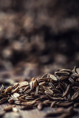 Cumin.Caraway seeds on wooden table. Cumin in vintage bronze bowl and spoon.