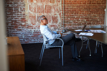 Fototapeta na wymiar Thoughtful Mature Businessman In Boardroom