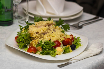 Salad with vegetables and cheese in restaurant