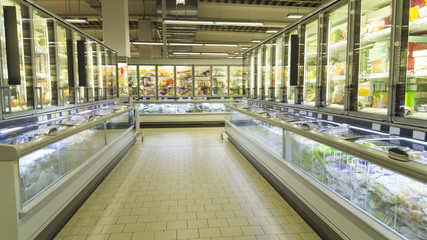 empty supermarket aisle with shelves full of products