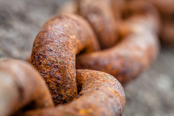 Color picture of a rusty metal chain, selective focus