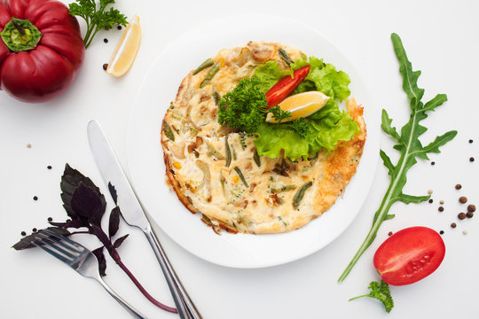 Omelet with mushrooms and basil flat lay. Top view on dish with scrambled eggs with vegetables and cutlery, free space. Breakfast, healthy food, morning meal concept