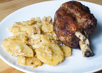 Baked pork knuckle with potatoes