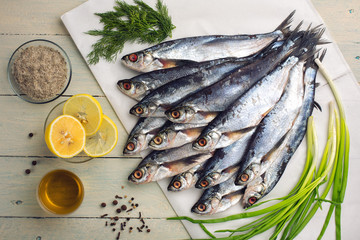 Raw river fish sabrefish on white paper