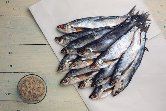 Raw river fish sabrefish on white paper