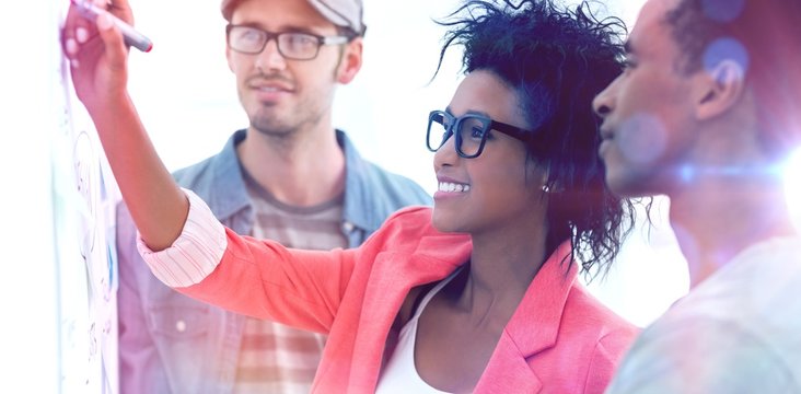 Artists in discussion in front of whiteboard