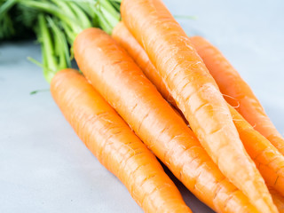 Fresh carrots on gray background. Healthy eating diet concept. Vegetables frame on table. Raw organic food