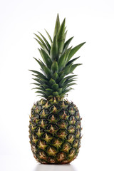 A whole fresh pineapple against a white background side view