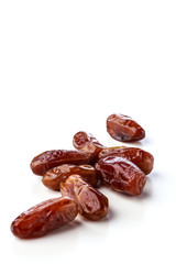 Fresh brown dates with seeds on a white background