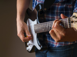 Young man playing an electric guitar