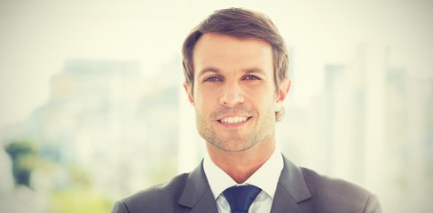 Fototapeta na wymiar Businessman standing over blurred background outdoors