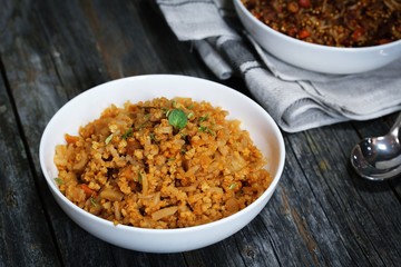Spicy Quinoa Pilaf served in a bowl on dark wooden background