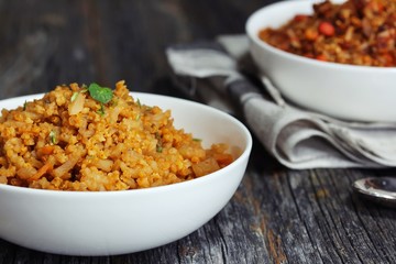 Spicy Quinoa Pilaf served in a bowl on dark wooden background