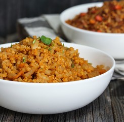 Spicy Quinoa Pilaf served in a bowl on dark wooden background