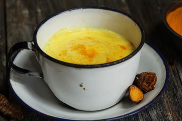 Turmeric Drink /  Golden Milk  on dark moody background, selective focus