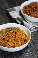 Spicy Quinoa Pilaf served in a bowl on dark wooden background