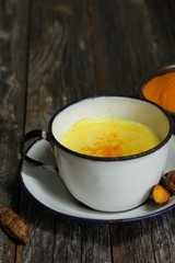 Turmeric Drink /  Golden Milk  on dark moody background, selective focus