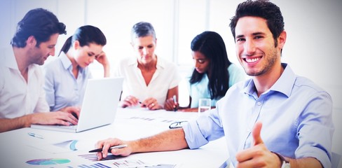 Attractive businessman smiling in the workplace