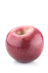 Isolated ripe red apple with shine and spots on a studio white background