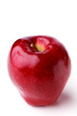 Spotted single ripe juicy red apple with stem on a white background