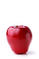 Closeup of a shiny spotted red apple on a white background
