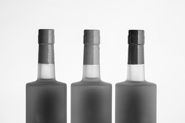 Three alcohol bottle tops in black and white with a white background