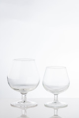 Empty clear short stem wine glasses on a white background